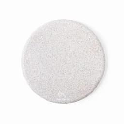 A wireless charging pad in a smooth, light grey finish with branding on the surface.