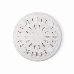 A light grey round product with a textured surface and small holes throughout, featuring four circular elements.