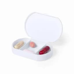 A pillbox containing four capsules of various shapes and colours, placed on a white background.