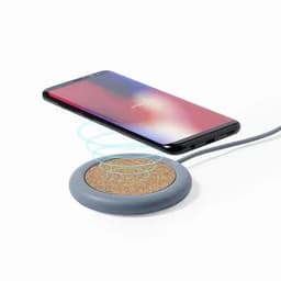 A wireless phone charger with a grey base and cork surface, charging a smartphone above it.