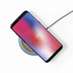 A smartphone on a round wireless charger with a grey colour scheme, displaying a battery percentage of 97%.