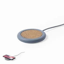 A wireless charger with a round cork surface and a grey base, featuring a cable for connection.
