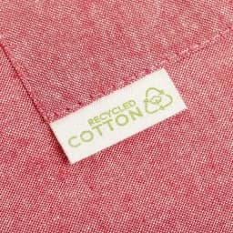 A close-up of a pink fabric showing a tag that reads "Recycled Cotton" with a recycling symbol.