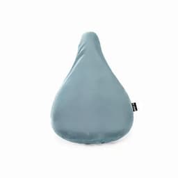 A bike seat cover in a light teal colour with a smooth, rounded shape and a small branding tag.