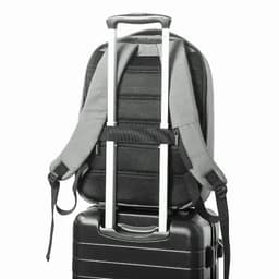 A grey backpack secured on top of a black suitcase, featuring adjustable straps and a telescopic handle.