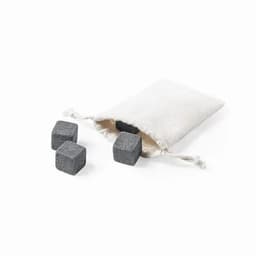A drawstring bag contains several grey whisky stones. The bag is light-coloured, with stones visible outside.