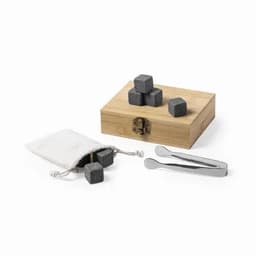 A wooden gift box containing grey whisky stones, a pouch with additional stones, and metal tongs.