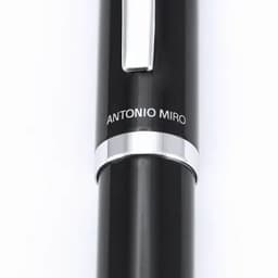 A black pen with a silver clip and band featuring a branding detail.