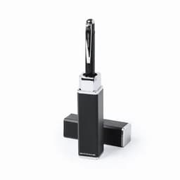 A black and silver promotional product with a sleek design and a pen on top, featuring a logo.