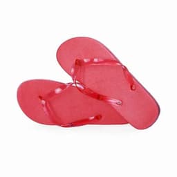 A pair of red flip-flops with a textured surface and transparent straps.