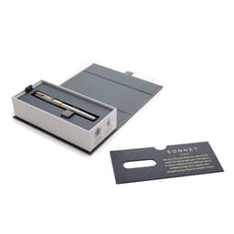 A metal rollerball pen in brushed stainless steel, presented in a grey box with a card, featuring a logo.