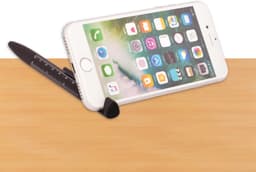 A black 6-in-1 multi pen designed with a built-in phone stand and a ruler, placed on a wooden surface.