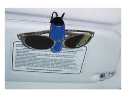 A blue sunglass holder with a pair of sunglasses attached, mounted on a car visor.