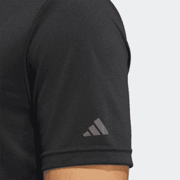 A black polo shirt with a short sleeve, featuring a branding logo on the arm.