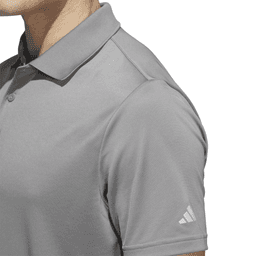 A grey Adidas men's polo shirt featuring a logo on the sleeve and a classic collar design.