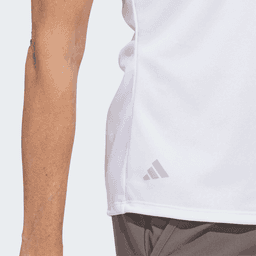 A white women's polo shirt featuring a logo on the side, made from recycled materials.