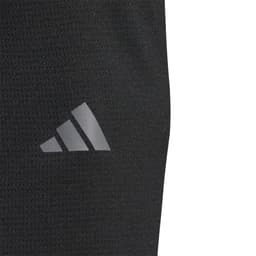 A close-up of a black pullover featuring a logo on the side. The fabric appears lightweight and textured.