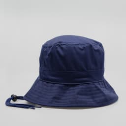 A navy blue bucket hat featuring a logo and a chin strap for secure wear.