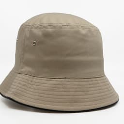 A tan bucket hat featuring a wide brim and vent holes, with a contrasting black underside.
