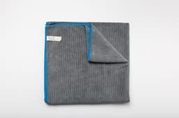 A grey car drying towel with blue stitching, folded neatly on a white background. It has a logo present.