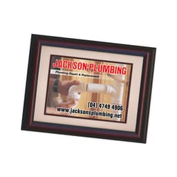 A magnetic photo frame in dark wood, displaying a plumbing service advertisement with a white background.
