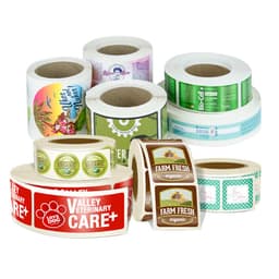 Rolls of printed stickers in various designs and colours, including some with logos and branding.