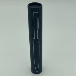 A metal pen presented in a sleek black cylindrical case with a logo.