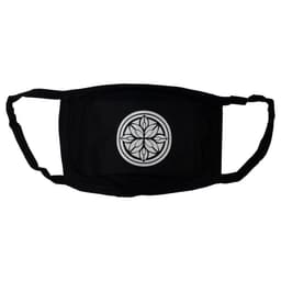 A black cotton face mask featuring a circular design in the centre. The mask has ear straps and a logo.