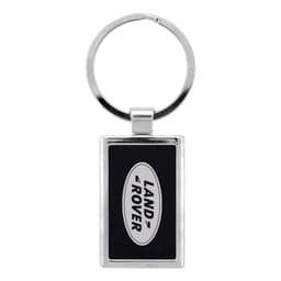 A silver keychain featuring a rectangular design with a black background and a logo.
