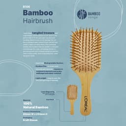 A bamboo hairbrush with a wooden handle and bristles, featuring a kraft sleeve and a logo.