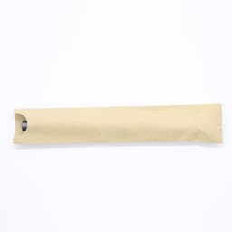 A brown paper packaging tube with a rounded end, containing a pen.