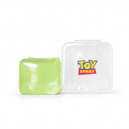 A green jelly cube sensory toy next to a clear container featuring a logo.