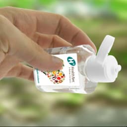 A 60ml clear hand sanitiser gel bottle with a white cap, containing 75% ethyl alcohol. Branding is visible.