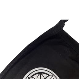 A black cotton face mask with a silver logo on the front and a stitched edge.