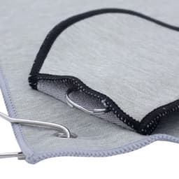 A grey golf towel with a black trim and a metal grommet for attachment. It features a smooth texture.