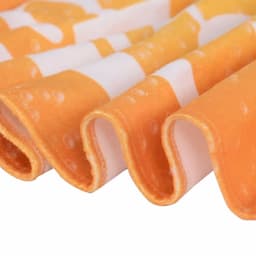 An orange gym towel with a textured surface, featuring a repeating pattern. It has a logo on one side.