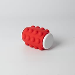 A red spinner with a textured surface and white ends, featuring rounded bumps. It has a logo on one side.