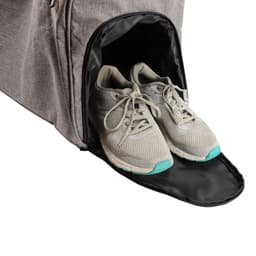 A grey wheeled duffel bag with a side compartment showcasing a pair of light grey athletic shoes.