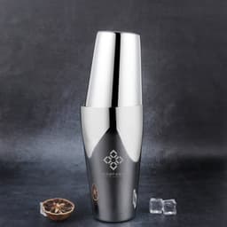 A stainless steel cocktail shaker in shiny silver, featuring two sizes, alongside ice cubes on a dark background.