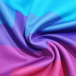 A vibrant polyester spandex fabric in blue, purple, and pink shades, showcasing a smooth, swirling texture.