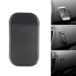 A black dashboard mat with a textured surface, designed to hold small items like phones and keys in place.