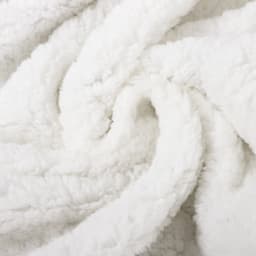 A white, fluffy blanket with a soft, textured surface, showcasing its cozy and luxurious feel.