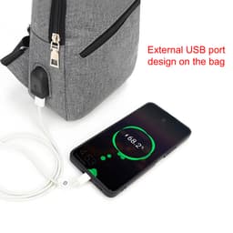 A grey travel sling chest bag with a USB port, paired with a charging phone displaying the battery percentage.
