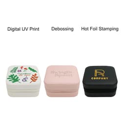 A set of three PU leather jewellery boxes in white, pink, and black, featuring decorative designs and branding.