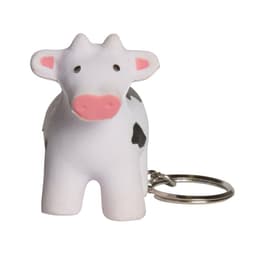A white and black cow-shaped stress reliever keyring with a metal keychain attached.