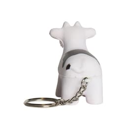 A keyring featuring a white and black cow stress reliever with a metal chain attached.
