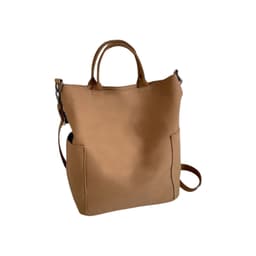 A tan vintage style canvas bag with two side pockets and both handles and a shoulder strap.