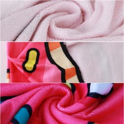 A custom-shaped beach towel featuring a pink background with vibrant patterns in red, yellow, and blue, showcasing its soft texture.