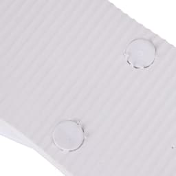 A close-up of white EVA material with ribbed texture and circular indentations. The image features a logo.