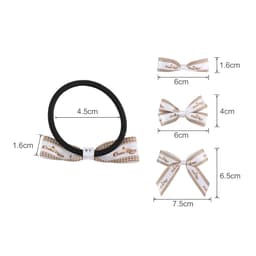 A set of elastic hair bows in white and brown, featuring various sizes and a black hair tie.